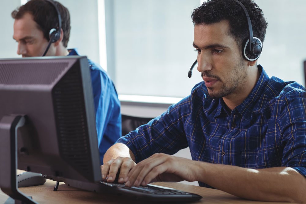 focused businessman working on computer at call