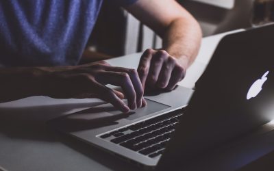 person-touching-open-macbook-on-table-839465